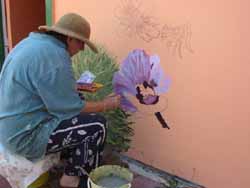 Sherry Vincent at work on a new mural in Herberton